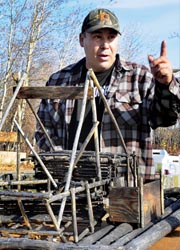 Tour guide and local resident Cliff Adams explains to visitors the way of life in Beaver, Alaska. // (C) 2010 Christopher Batin