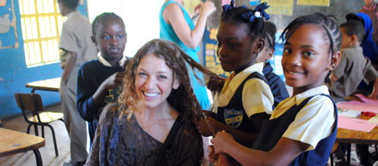Assistant Editor Mindy Poder takes a break from reading with the new friends she met on The Reading Road Trip, the first voluntourism opportunity offered by Sandals. // © 2011 Mindy Poder F