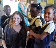 Assistant Editor Mindy Poder takes a break from reading with the new friends she met on The Reading Road Trip, the first voluntourism opportunity offered by Sandals. // © 2011 Mindy Poder