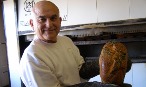 Pratt Morales, owner of the Golden Crown Panderia, with a loaf of green chile bread. // © Fran Golden 2010 F