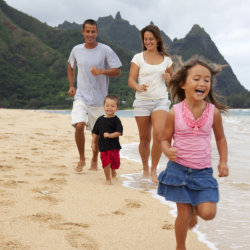 Family running on a beach in Hawaii // © 2013 iStock Images